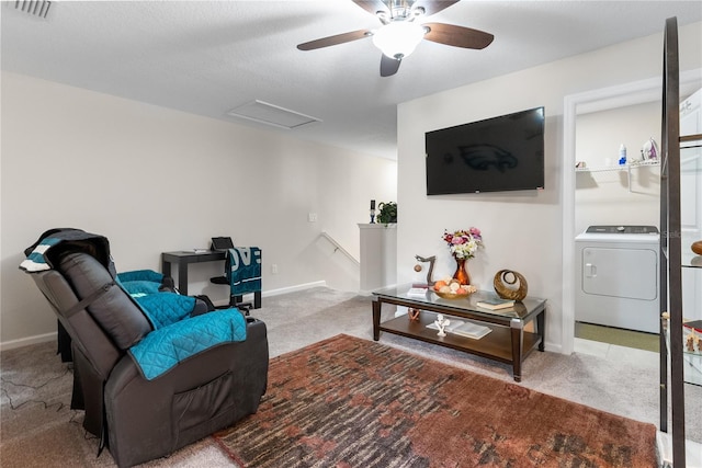 carpeted living room with washer / dryer