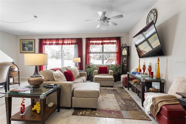 living room with ceiling fan and light hardwood / wood-style flooring