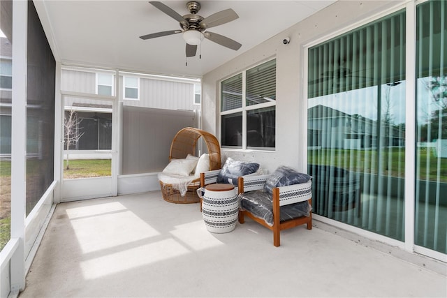 sunroom / solarium featuring ceiling fan