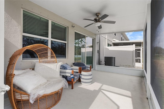 sunroom / solarium featuring ceiling fan