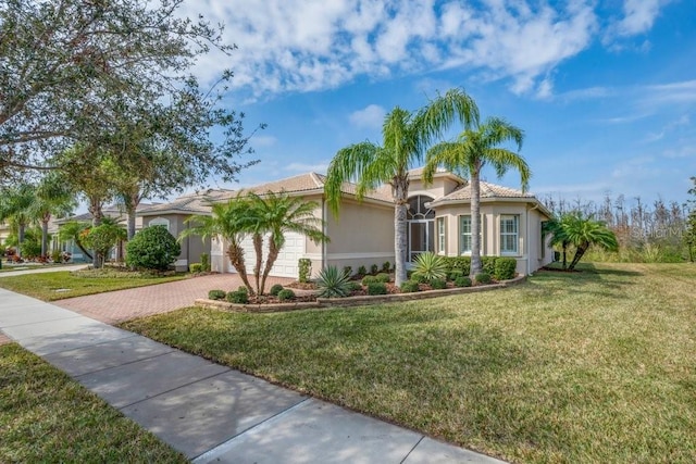 mediterranean / spanish home with a front lawn