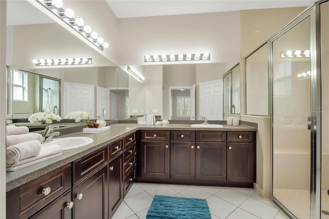 bathroom featuring vanity, tile patterned floors, and a shower with shower door