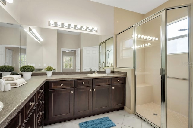 bathroom featuring walk in shower, tile patterned floors, and vanity