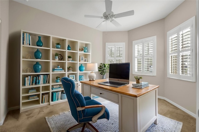 office space with ceiling fan and light colored carpet