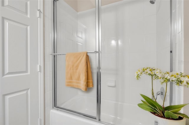 bathroom with shower / bath combination with glass door