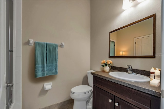 bathroom with vanity, tile patterned floors, and toilet