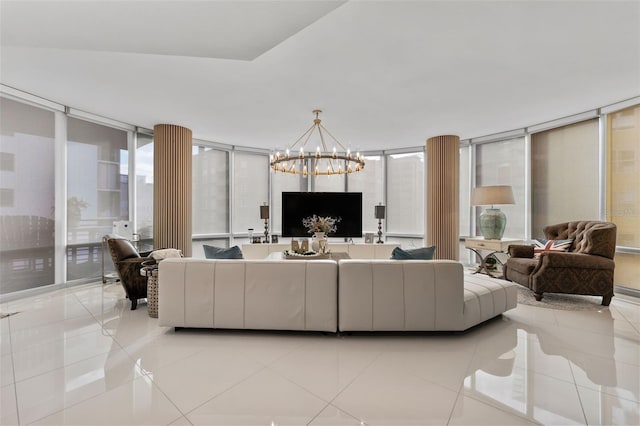 living room with light tile patterned floors, a wall of windows, and a chandelier