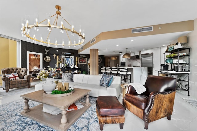 living room featuring light tile patterned flooring and decorative columns