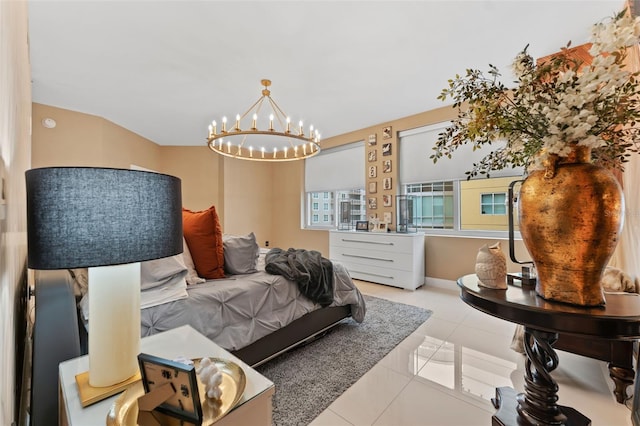 tiled bedroom featuring a notable chandelier