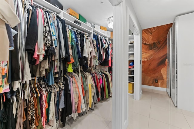 spacious closet with light tile patterned floors