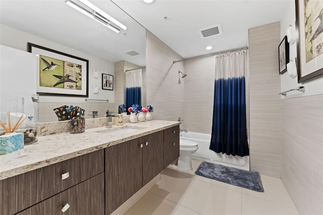 full bathroom featuring toilet, vanity, tile patterned flooring, and shower / bath combo with shower curtain