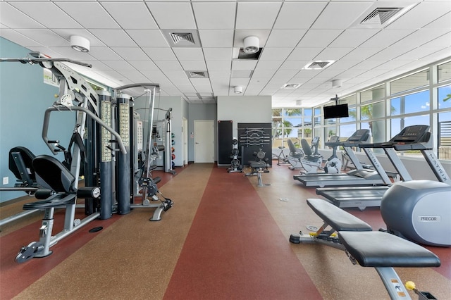 exercise room with a wall of windows and a paneled ceiling