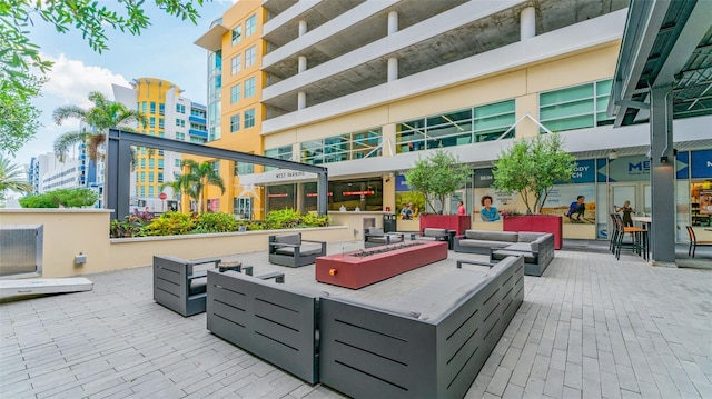 view of patio / terrace featuring an outdoor living space with a fire pit