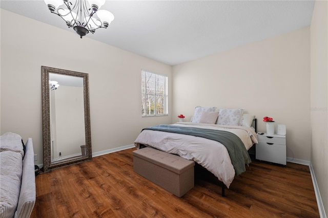 bedroom featuring dark wood-type flooring and a chandelier