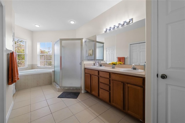 bathroom featuring vanity, shower with separate bathtub, and tile patterned flooring