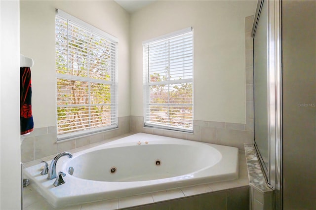 bathroom featuring tiled tub