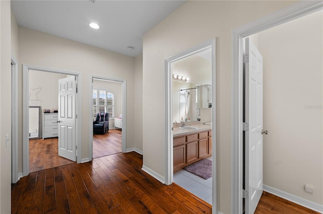 hall with sink and dark hardwood / wood-style floors