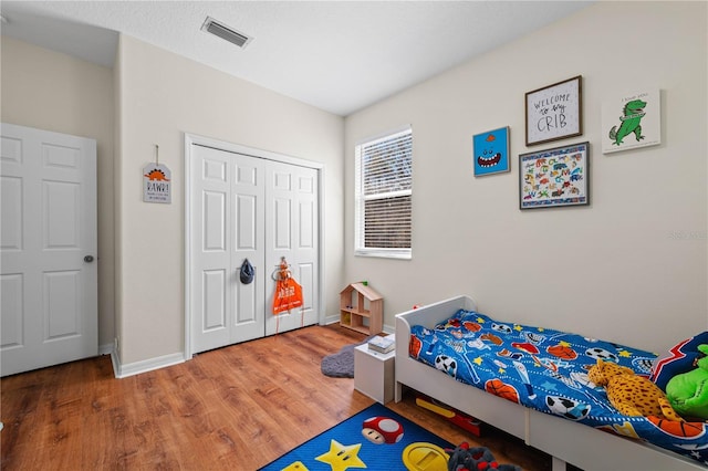 bedroom with hardwood / wood-style flooring and a closet