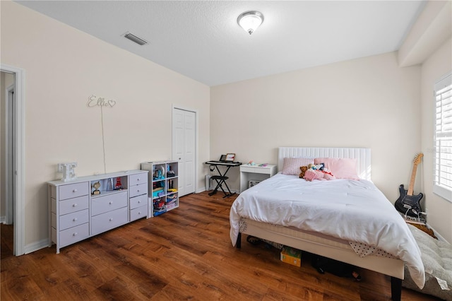 bedroom with dark hardwood / wood-style flooring