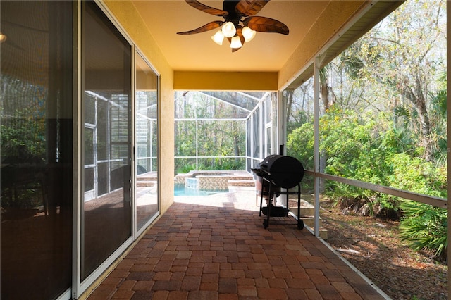 unfurnished sunroom with ceiling fan