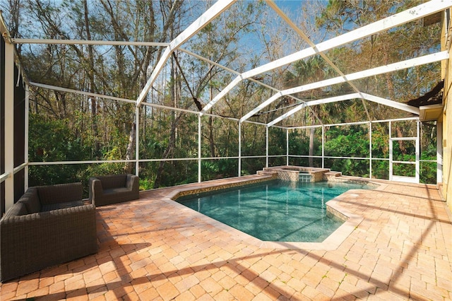 view of pool with an in ground hot tub, a lanai, an outdoor hangout area, and a patio area