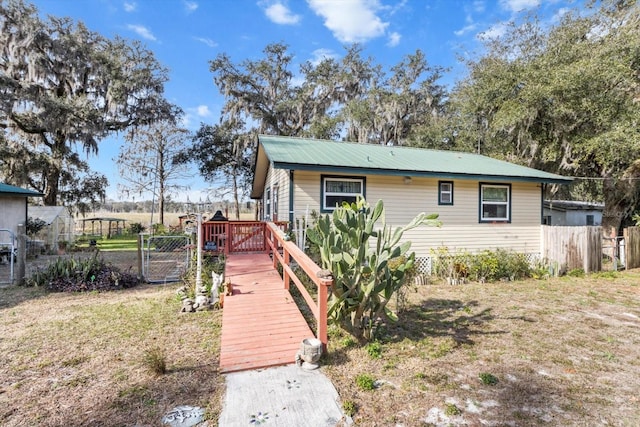 view of front facade with a front yard and a deck