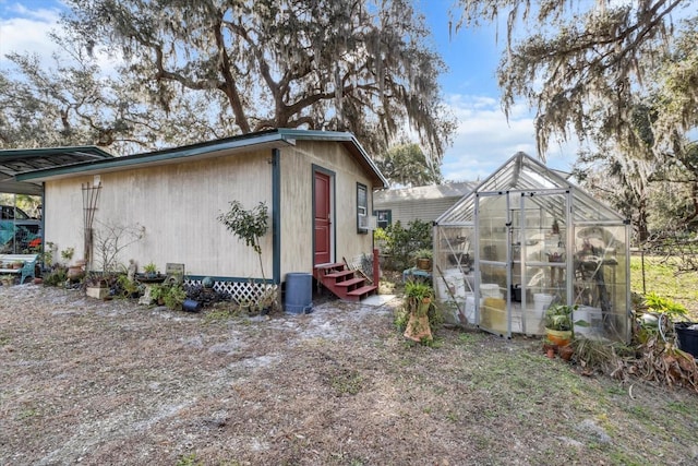 view of side of property with an outbuilding