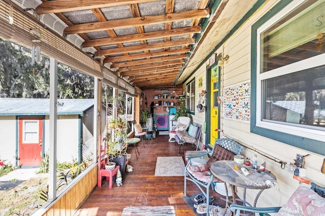 sunroom featuring vaulted ceiling and plenty of natural light