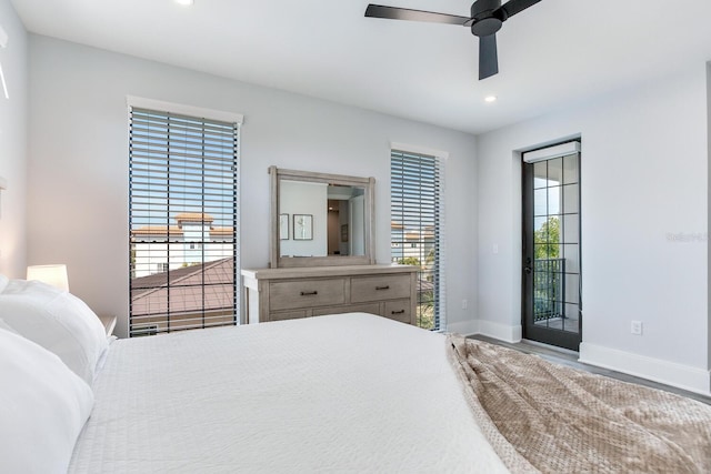 bedroom featuring ceiling fan, access to exterior, and multiple windows