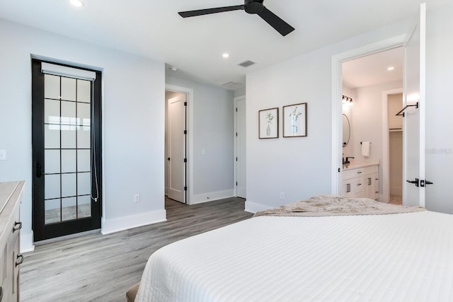 bedroom with ensuite bath, ceiling fan, and light wood-type flooring