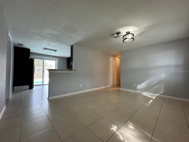 unfurnished living room with light tile patterned flooring