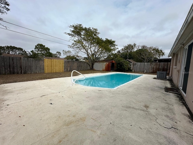 view of swimming pool with a patio and central AC