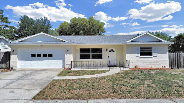 ranch-style house featuring concrete driveway, fence, stone siding, a front yard, and a garage