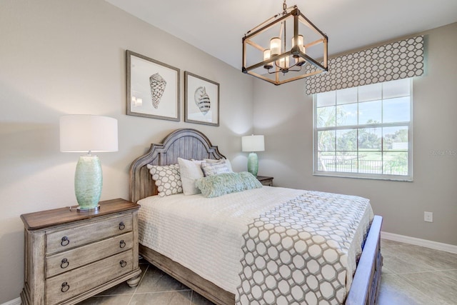 bedroom with light tile patterned flooring and a chandelier