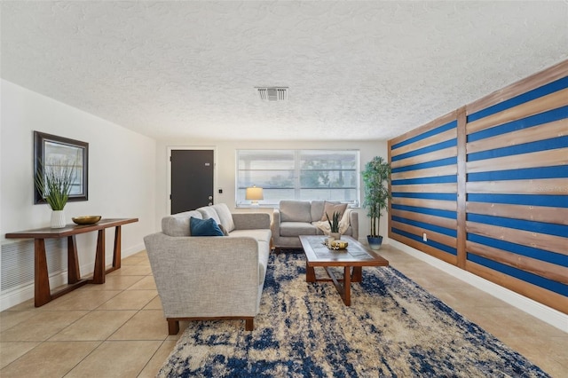 tiled living room featuring a textured ceiling