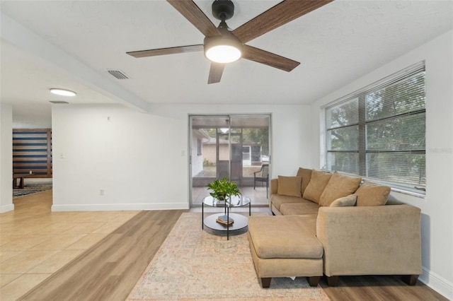 living room featuring ceiling fan and wood-type flooring