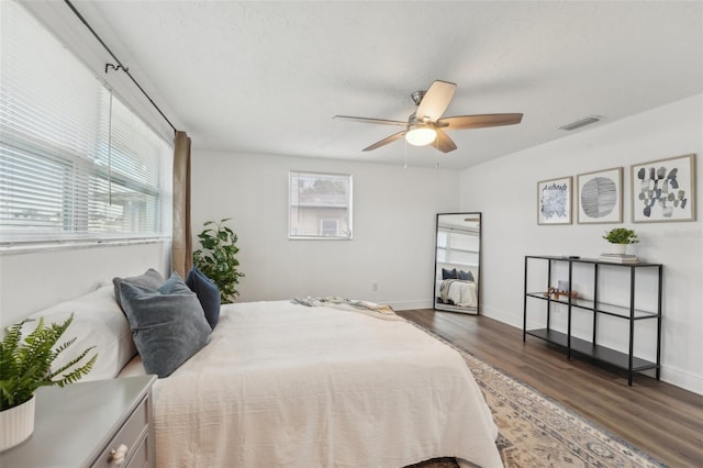 bedroom featuring ceiling fan and dark hardwood / wood-style flooring