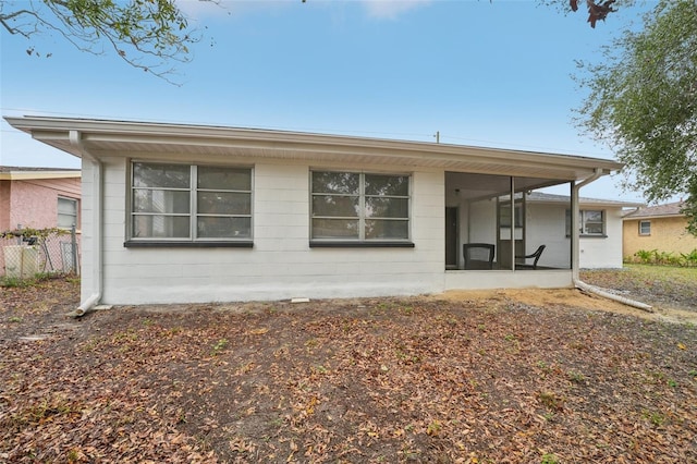 back of property with a sunroom