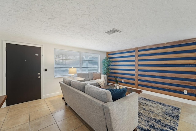 living room with light tile patterned floors and a textured ceiling