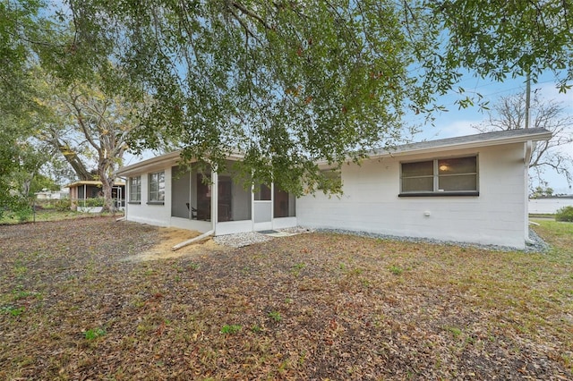 back of property featuring a sunroom