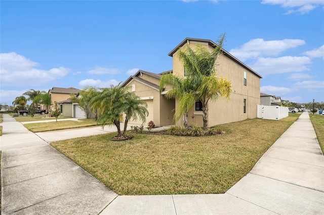 view of front facade featuring a front lawn and a garage