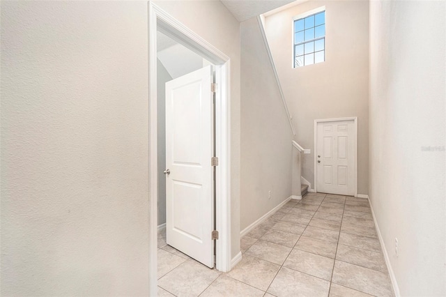 hall with light tile patterned floors