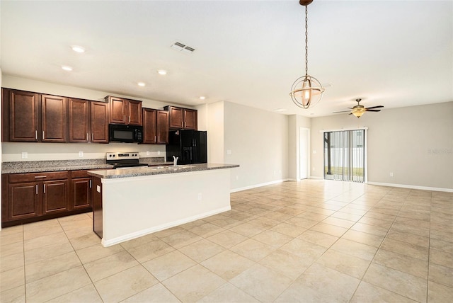 kitchen with light stone countertops, pendant lighting, black appliances, an island with sink, and light tile patterned flooring