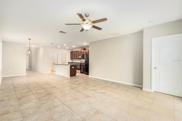 unfurnished living room with ceiling fan, light tile patterned floors, and sink