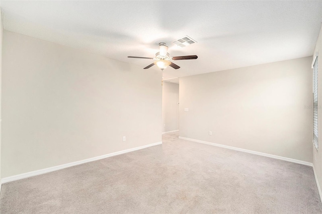 carpeted empty room featuring a textured ceiling and ceiling fan