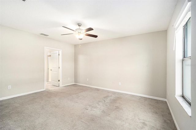 carpeted spare room with ceiling fan and a healthy amount of sunlight