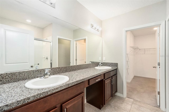 bathroom with vanity, tile patterned floors, and walk in shower