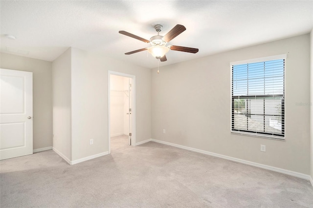 unfurnished room featuring ceiling fan and light colored carpet