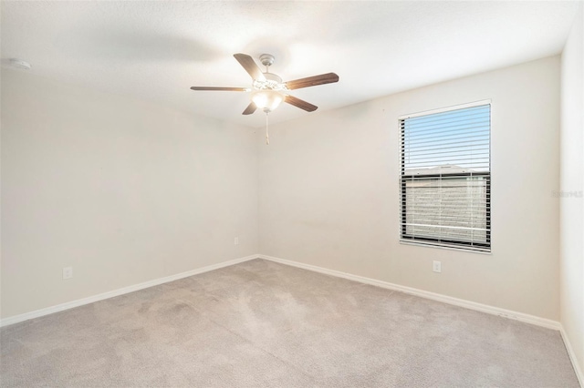 carpeted spare room with ceiling fan