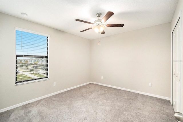 unfurnished room featuring ceiling fan and light colored carpet